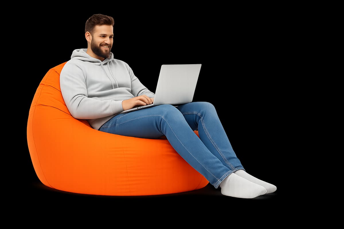 Professional working on laptop in orange bean bag chair